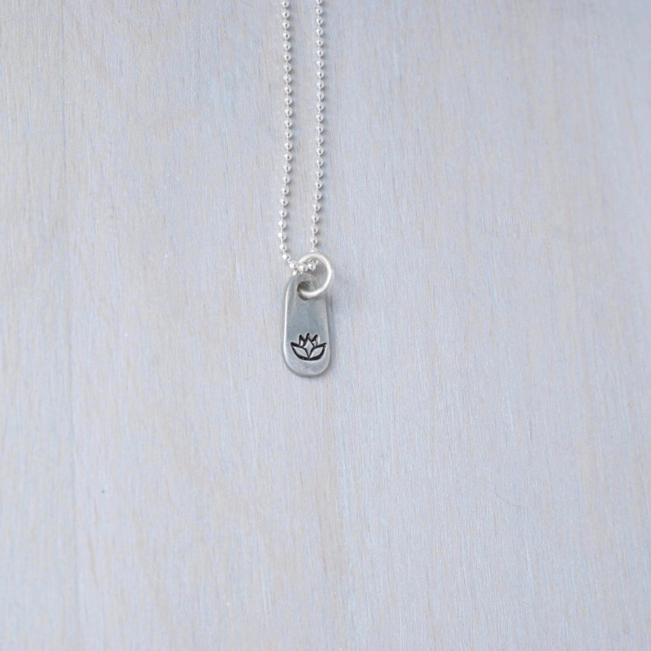 Silver lotus necklace in artisan pewter