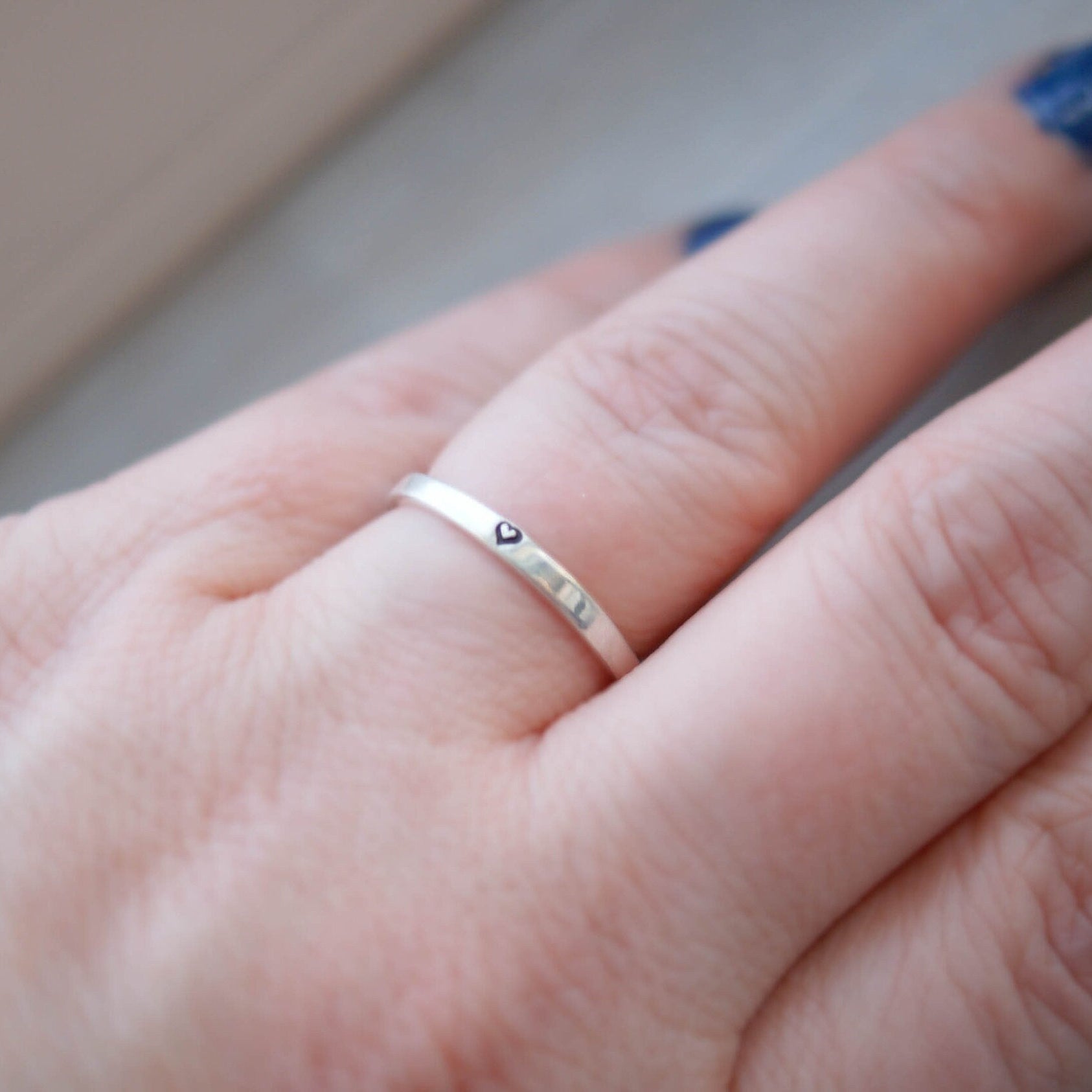 Sterling silver ring stamped with small heart on hand