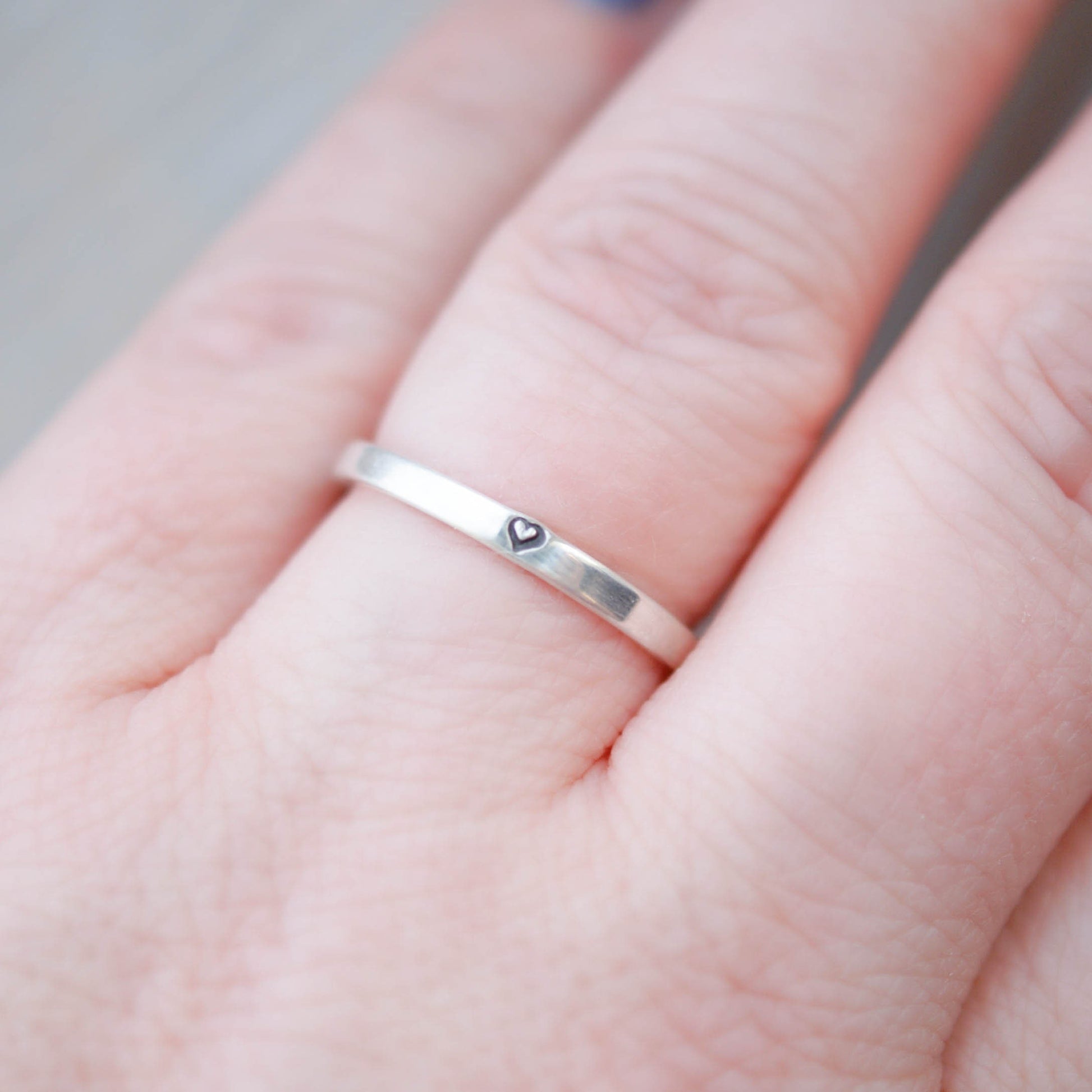 Sterling silver ring stamped with small heart on hand
