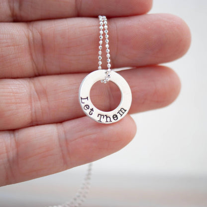 Image of Let Them Self Worth Sterling Silver Necklace being held in hand.