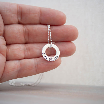 Image of Let Them Encouragement Gift Sterling Silver Necklace being held in hand.