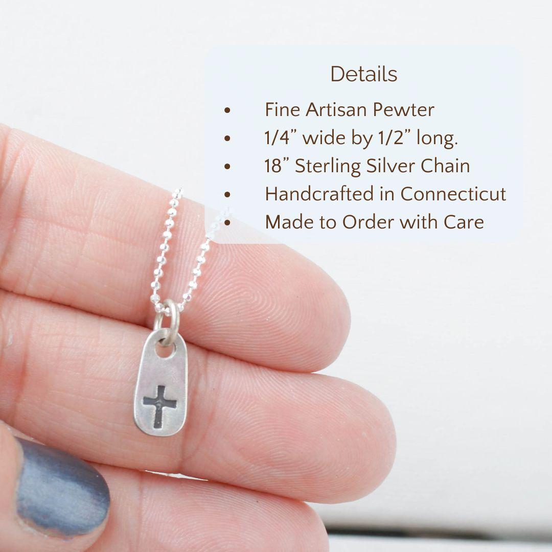 image of tiny cross necklace with details: fine artisan pewter, 1/4" x 1/2" long, 18" sterling silver chain.