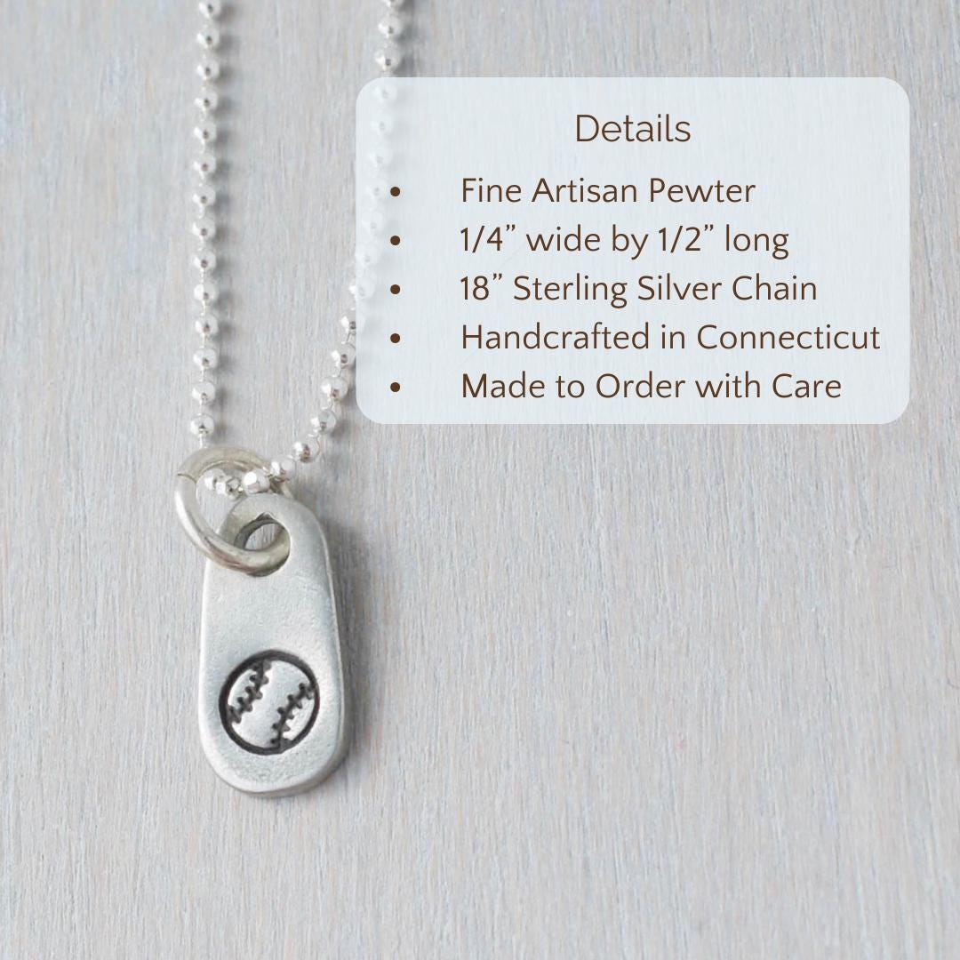 image of silver baseball necklace being held in hand with text overlay that says
Product Details, Fine Artisan Pewter , 1/4” wide by 1/2” long, 18” Sterling Silver Chain, Handcrafted in Connecticut, Made to Order with Care