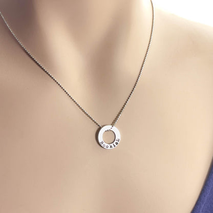 image of bookish sterling silver necklace on a neck