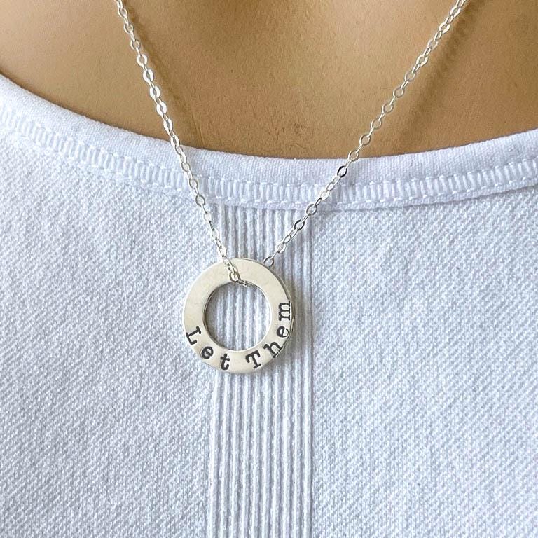 Sterling Silver Necklace stamped with Let Them on white background