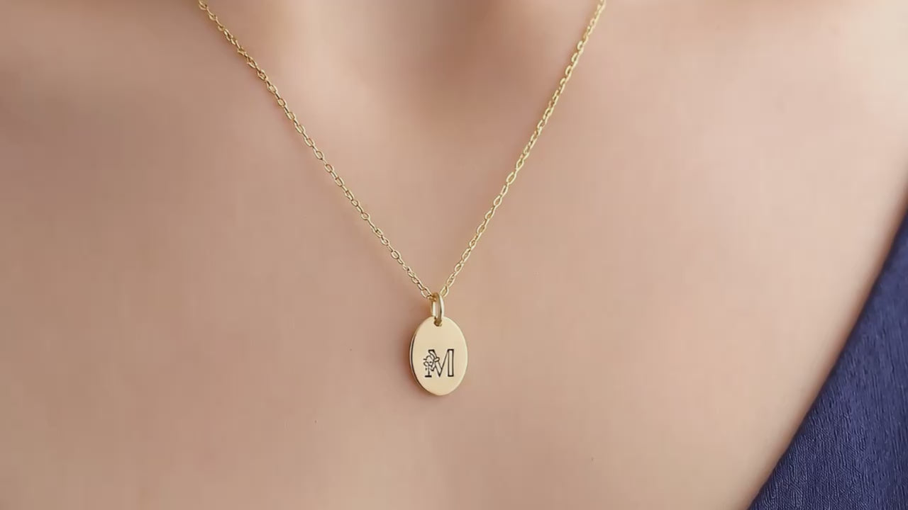 video of gold filled initial necklace on mannequin and being held in hand