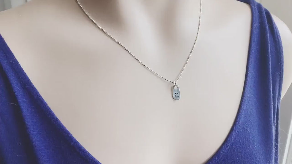 Petite Silver Necklace in Artisan Pewter with handstamped kitty face on neck and being held