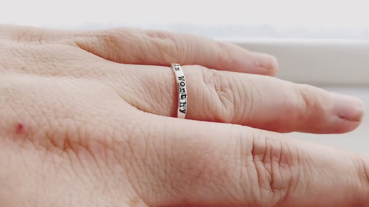 Sterling Silver Ring handstamped with I Am Worthy on hand and being held