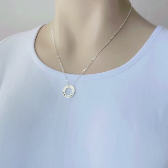 video of bookish necklace held in hand and on a mannequin