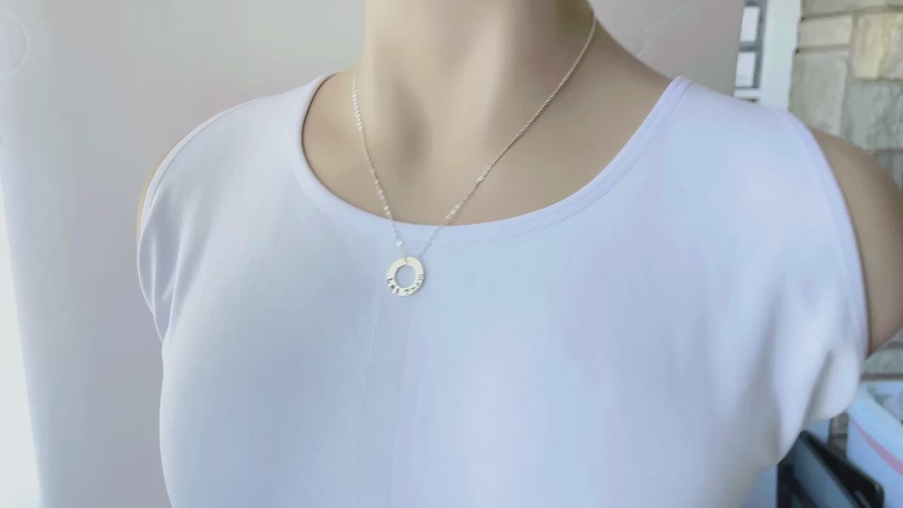 video of bookish necklace held in hand and on a mannequin