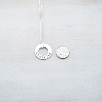 Choose Joy Circle Necklace in Sterling Silver next to dime for scale
