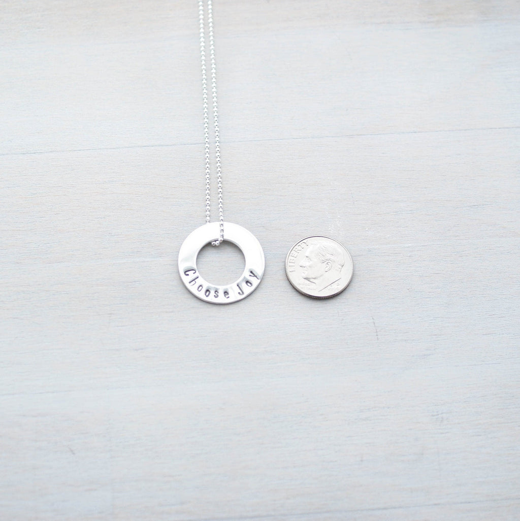 Choose Joy Circle Necklace in Sterling Silver next to dime for scale