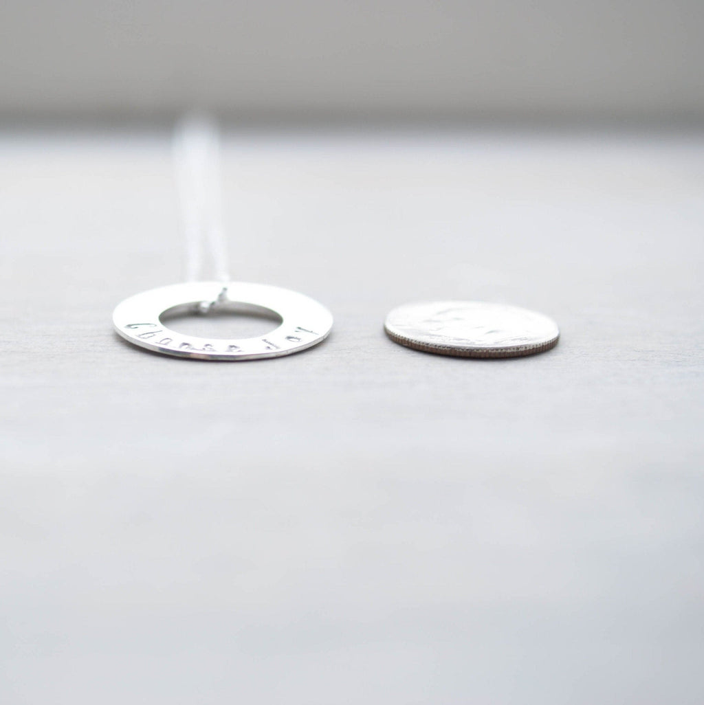 Choose Joy Circle Necklace in Sterling Silver next to dime for scale