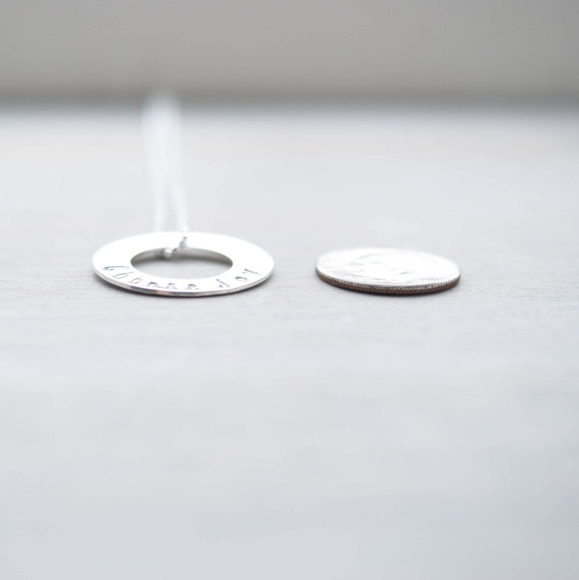 Choose Joy Circle Necklace in Sterling Silver next to dime for scale