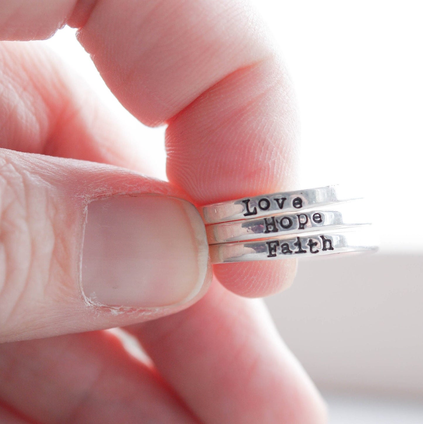 3 Sterling silver rings stamped with Faith, hope and love in between fingers