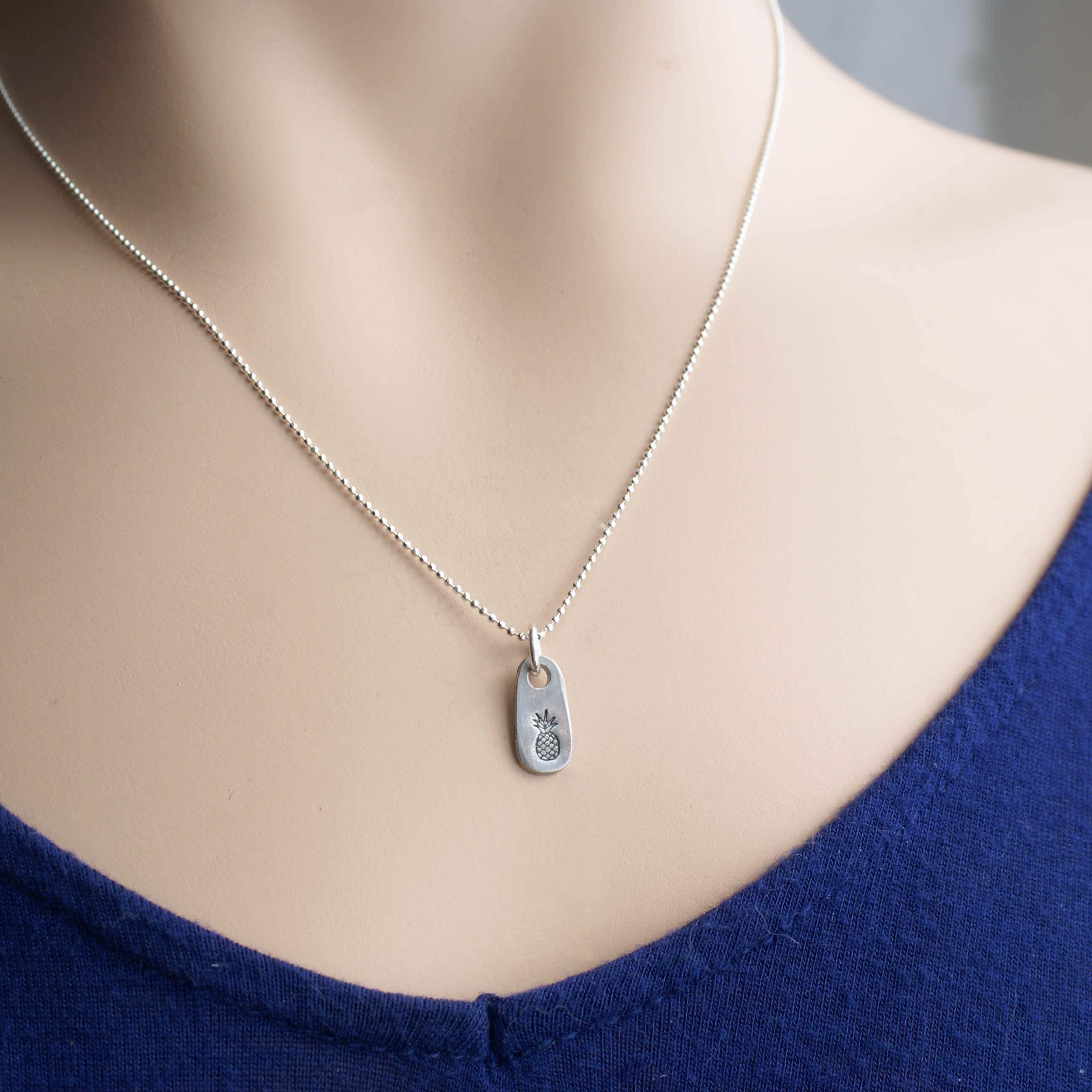 Dainty silver Pineapple necklace in artisan pewter on neck