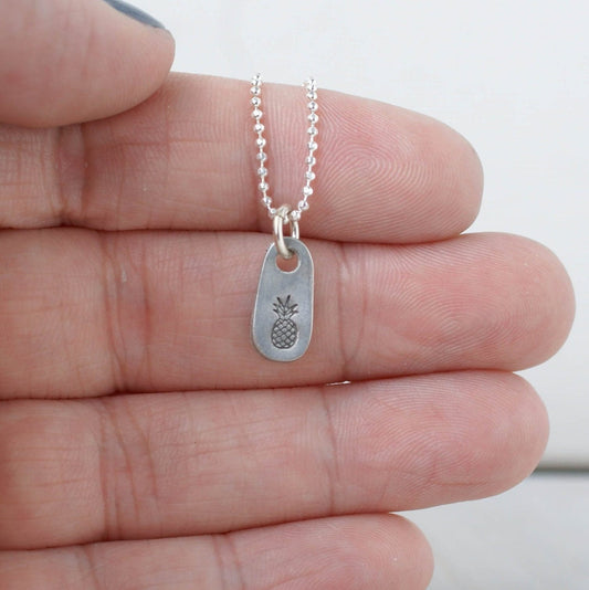Dainty silver Pineapple necklace in artisan pewter on hand
