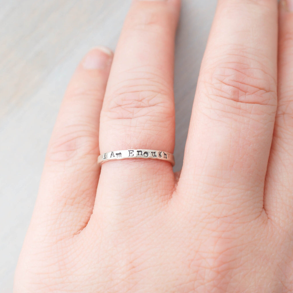 Sterling Silver stacking ring handstmaped with I Am Enough on hand