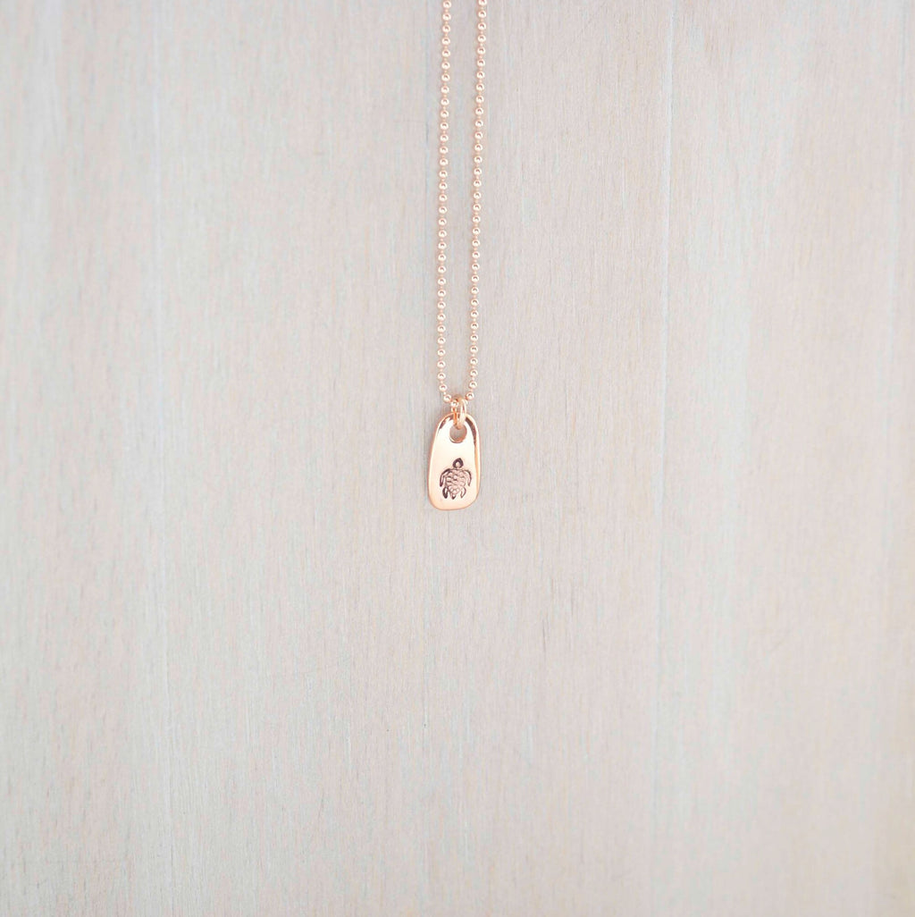 Rose gold necklace stamped with a turtle