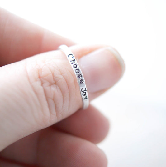 Stacking ring in Sterling silver handstamped with Choose Joy on thumb