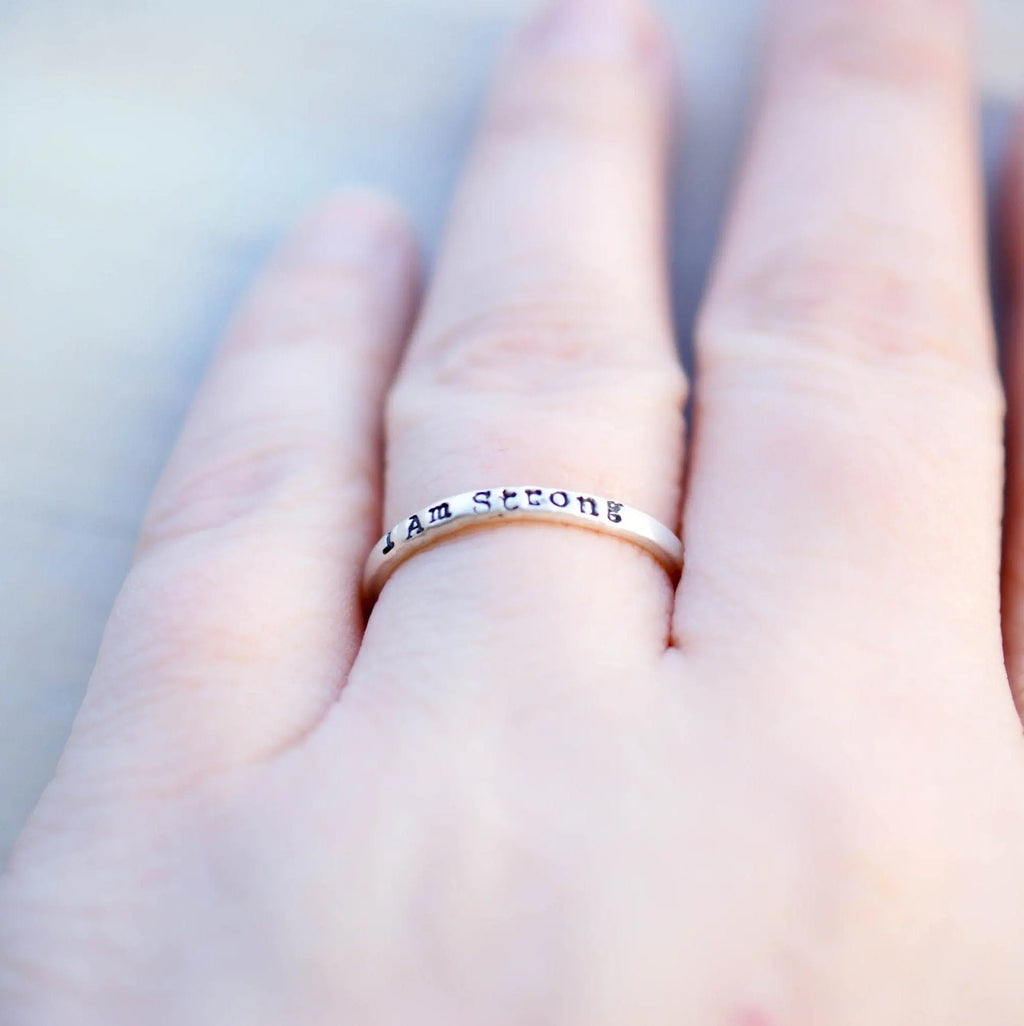 Sterling Silver stacking ring handstmaped with I Am Strong on hand