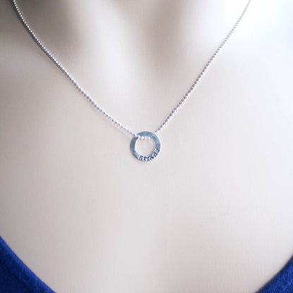 Sterling silver tiny circle stamped with Strong necklace on neck