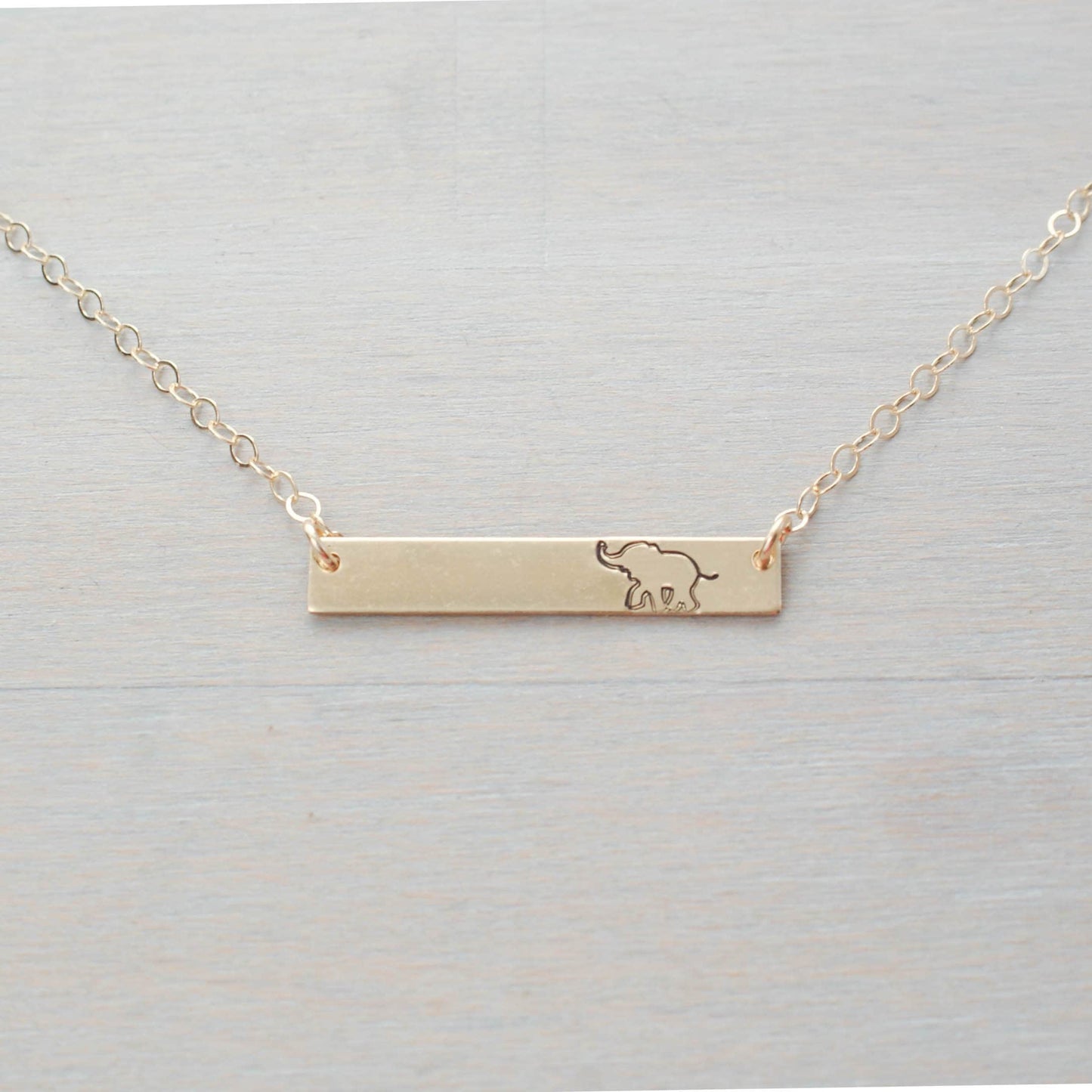 Gold bar neckalce stamped with elephant