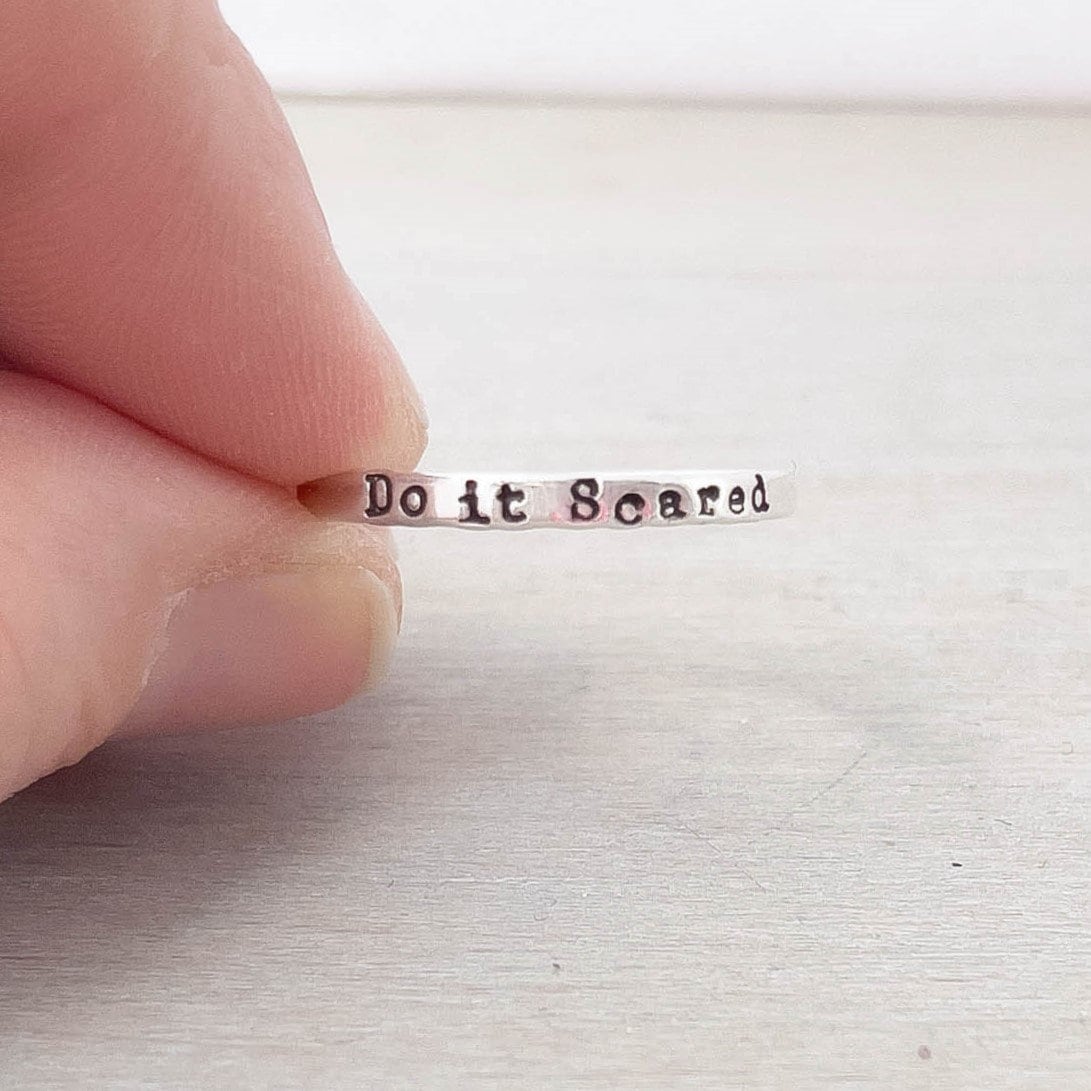 Image of Do it Scared Ring for Daughter in Sterling Silver being held
