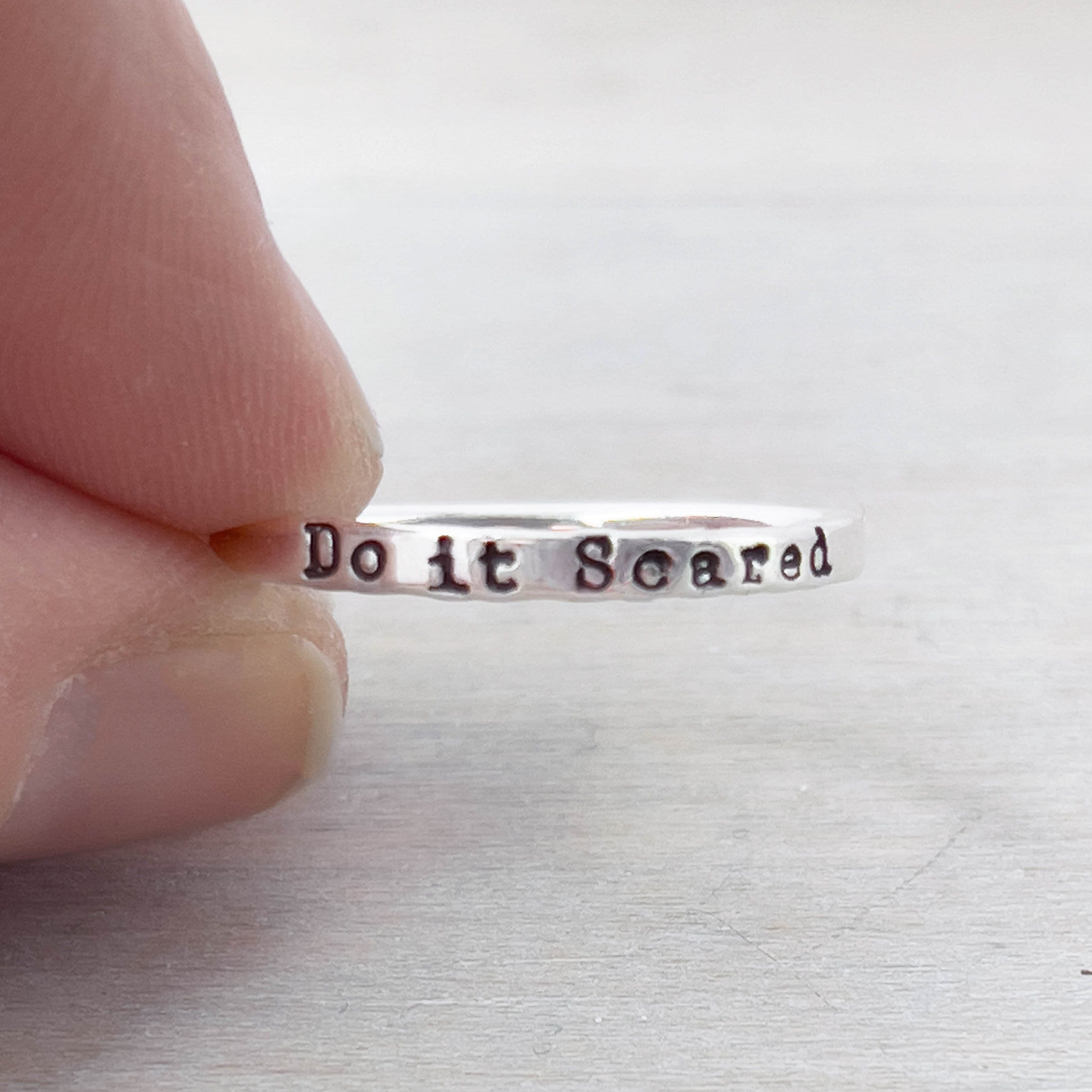 Image of Do it Scared Graduation Ring in Sterling Silver being held
